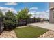 Backyard featuring a concrete patio, artificial turf, and a gravel border at 1813 W 67Th Ave, Denver, CO 80221