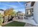 An overview of the backyard with outdoor furniture, a fire pit, and a well-maintained lawn at 1813 W 67Th Ave, Denver, CO 80221