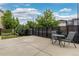 Backyard featuring a concrete patio with outdoor furniture and a dark wood fence at 1813 W 67Th Ave, Denver, CO 80221
