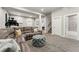 Spacious finished basement features gray sectional, and door to renovated bathroom at 1813 W 67Th Ave, Denver, CO 80221