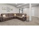 Finished basement with a large sectional couch, neutral walls, and carpet at 1813 W 67Th Ave, Denver, CO 80221