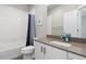 Modern bathroom with white tiled shower/tub and neutral toned vanity sink at 1813 W 67Th Ave, Denver, CO 80221