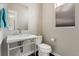 Modern half bath with a pedestal sink, contemporary fixtures, and a window at 1813 W 67Th Ave, Denver, CO 80221