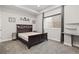 Bedroom featuring a dark wood frame bed and neutral walls at 1813 W 67Th Ave, Denver, CO 80221