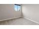 Minimalist bedroom with neutral colors, a large window, and soft carpeting for a cozy atmosphere at 1813 W 67Th Ave, Denver, CO 80221