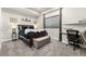 Modern bedroom with a dark wood bed frame, bench, window and work station at 1813 W 67Th Ave, Denver, CO 80221