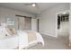 Relaxing bedroom boasts a barn door, neutral colors, and access to a walk-in closet with custom shelving at 1813 W 67Th Ave, Denver, CO 80221