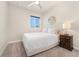 Cozy bedroom features neutral tones, plush carpet, ceiling fan, and natural light from a window at 1813 W 67Th Ave, Denver, CO 80221
