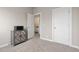 Neutrally decorated bedroom featuring access to a bathroom and closet, and carpeted floors at 1813 W 67Th Ave, Denver, CO 80221