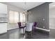 Dining room features a modern chandelier, sleek dark accent wall and seating for four at 1813 W 67Th Ave, Denver, CO 80221