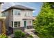 Modern two-story home featuring a turquoise front door, brick accents, and a well-manicured front yard at 1813 W 67Th Ave, Denver, CO 80221