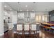 Bright kitchen with pendant lights, a center island with seating, stainless steel appliances and a dining table at 1813 W 67Th Ave, Denver, CO 80221