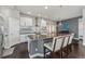 Stylish kitchen with modern white cabinets, a large island, stainless steel appliances, and nice pendant lighting at 1813 W 67Th Ave, Denver, CO 80221
