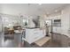 Open kitchen showcases an island with seating, stainless steel sink, and views into the living area at 1813 W 67Th Ave, Denver, CO 80221