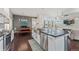 Spacious kitchen with an island, stainless steel appliances, modern backsplash and open to the living room at 1813 W 67Th Ave, Denver, CO 80221