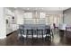 Modern kitchen with stainless steel appliances, dark countertops, and an island with bar stool seating at 1813 W 67Th Ave, Denver, CO 80221