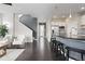 Modern living room and kitchen featuring sleek hardwood floors and an open-concept layout at 1813 W 67Th Ave, Denver, CO 80221