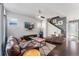 Comfortable living room featuring hardwood floors, a ceiling fan, and a flatscreen TV on the wall at 1813 W 67Th Ave, Denver, CO 80221