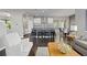 Open-concept kitchen and living area with modern finishes, stainless steel appliances, and hardwood floors at 1813 W 67Th Ave, Denver, CO 80221