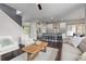 Spacious open-concept living room with hardwood floors connecting to a modern kitchen and dining area at 1813 W 67Th Ave, Denver, CO 80221