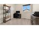 Bright home office with a large window, white board, bookshelf, and desk with dark finishings at 1813 W 67Th Ave, Denver, CO 80221