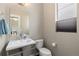 Stylish powder room features a modern sink, mirror, and natural light from a window at 1813 W 67Th Ave, Denver, CO 80221