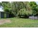 Large backyard featuring a shed, swimming pool, mature tree and plenty of green space for outdoor activities at 2885 Quay St, Wheat Ridge, CO 80033