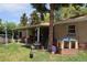 Backyard with a covered patio, playhouse, green grass, and toys at 2885 Quay St, Wheat Ridge, CO 80033