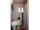 Compact bathroom featuring a sink, toilet, shower with decorative floral curtain, and artistic wall decor at 2885 Quay St, Wheat Ridge, CO 80033