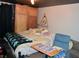 A bedroom with a bed, a blue chair, and a wardrobe at 2885 Quay St, Wheat Ridge, CO 80033