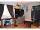 Relaxed bedroom with dark curtains, cartoon themed wall art, and a ceiling fan at 2885 Quay St, Wheat Ridge, CO 80033