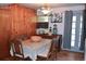 Warm dining room with wood paneling, a large table, and a vintage chandelier at 2885 Quay St, Wheat Ridge, CO 80033