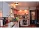 Kitchen with wood cabinets, tile countertops, and open shelves displaying decor and dishware at 2885 Quay St, Wheat Ridge, CO 80033