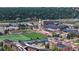 An aerial view showing a University Campus with sports fields, tennis courts, and the surrounding city at 2405 S Franklin, Denver, CO 80210