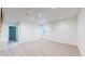 This well-lit basement offers neutral carpet, white walls, and a large window at 2405 S Franklin, Denver, CO 80210