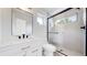Modern bathroom with a sleek black shower and stylish white vanity with gold hardware at 2405 S Franklin, Denver, CO 80210