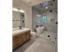 Modern bathroom features a freestanding tub, glass-enclosed shower, and elegant vanity with marble countertop at 2405 S Franklin, Denver, CO 80210