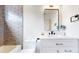 This modern bathroom features a tub-shower combo, gray subway tile, and sleek vanity at 2405 S Franklin, Denver, CO 80210