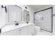 Modern bathroom with double sink vanity, sleek mirrors, and a glass-enclosed shower at 2405 S Franklin, Denver, CO 80210
