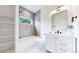 Cozy bathroom features a tub-shower combo, storage shelving and modern vanity at 2405 S Franklin, Denver, CO 80210