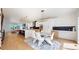 Bright, open-concept dining area features modern lighting, a gray area rug and dining table with white chairs at 2405 S Franklin, Denver, CO 80210