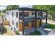 Modern duplex with light wood accents, balconies, and sleek black framed windows at 2405 S Franklin, Denver, CO 80210