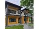 Modern two-story home boasts striking architectural details, including dual balconies and sleek black accents at 2405 S Franklin, Denver, CO 80210
