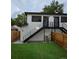 Modern home exterior featuring black railings, wood fencing, and a well-maintained yard at 2405 S Franklin, Denver, CO 80210