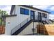 Modern home exterior showcasing dark metal stairs, a fenced yard and an air conditioning unit at 2405 S Franklin, Denver, CO 80210