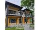 Modern two-story home boasts striking architectural details, including dual balconies and sleek black accents at 2405 S Franklin, Denver, CO 80210