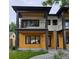 Contemporary home with clean lines, featuring a mix of wood and white siding, and minimalist landscaping at 2405 S Franklin, Denver, CO 80210