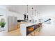 Modern kitchen featuring stainless steel appliances, island with seating, and custom cabinetry at 2405 S Franklin, Denver, CO 80210