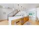 Open-concept kitchen featuring sleek cabinetry, modern appliances, and an eat-in island at 2405 S Franklin, Denver, CO 80210