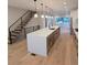 Modern kitchen features a spacious island, stainless steel appliances, and an open floor plan at 2405 S Franklin, Denver, CO 80210